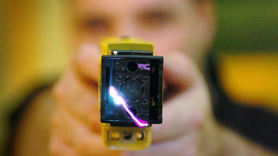 A taser being discharged by an officer