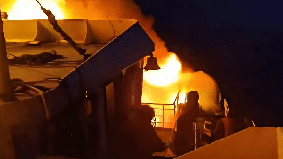 Flames engulf a ferry as a fire erupted in the night
