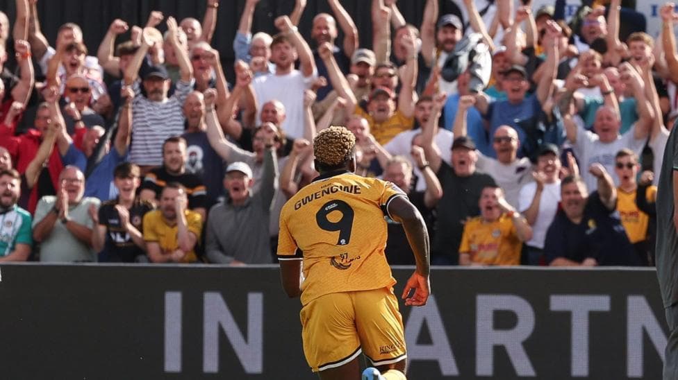 Shaquille Gwengwe runs towards a cheering crowd at Rodney Parade.