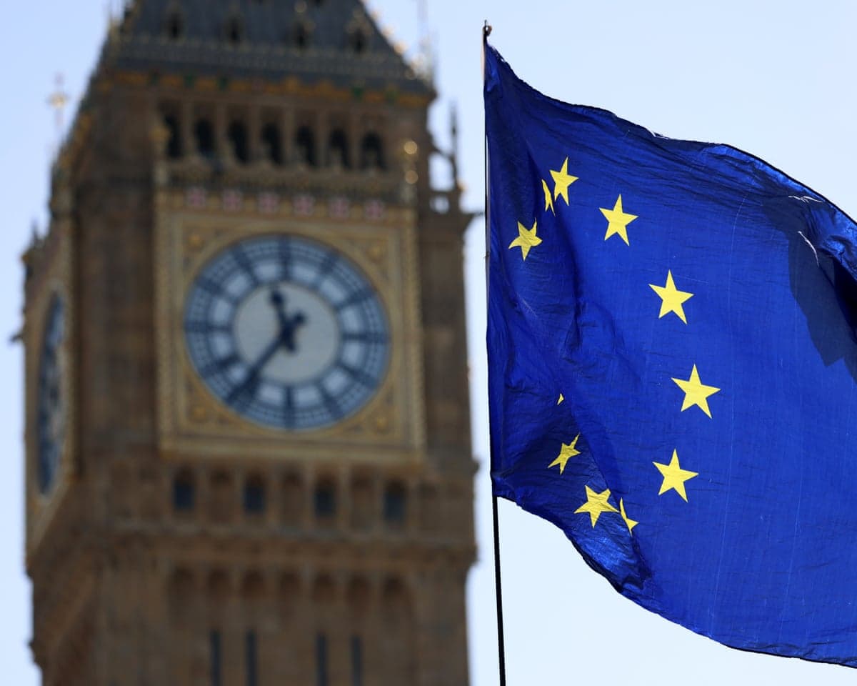 An EU flag flies in the wind outside Big Ben in London