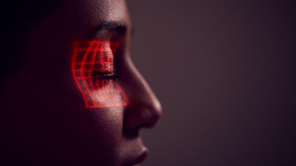 Facial Recognition Technology Concept As Woman Has Red Grid Projected Onto Eye In Studio