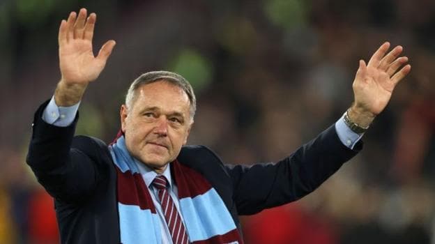 Ludek Miklosko, wearing a West Ham scarf, waves