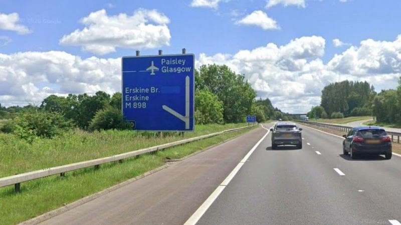 A motorway with a blue sign showing the exit the Erskine Bridge at junction 30