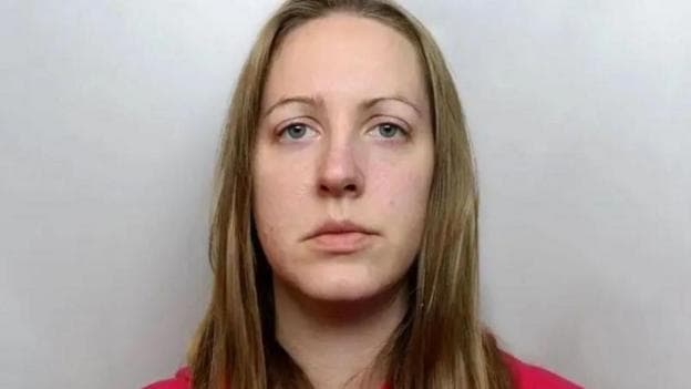 Custody image of Lucy Letby, who has long blonde hair and is wearing a red top.