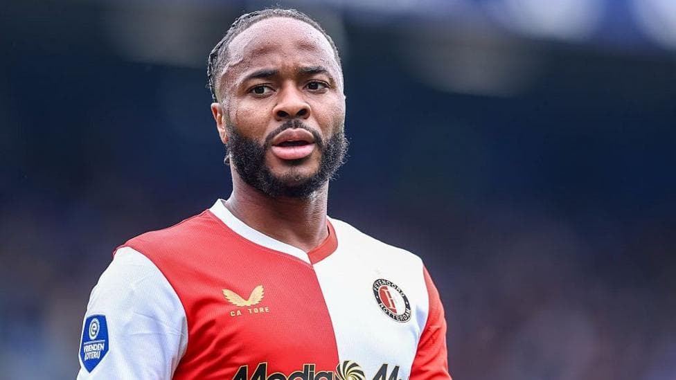 Raheem Sterling in a red and white Feyenoord club shirt.