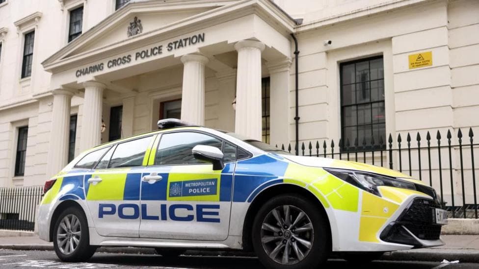 Outside Charing Cross police station with a car parked in front