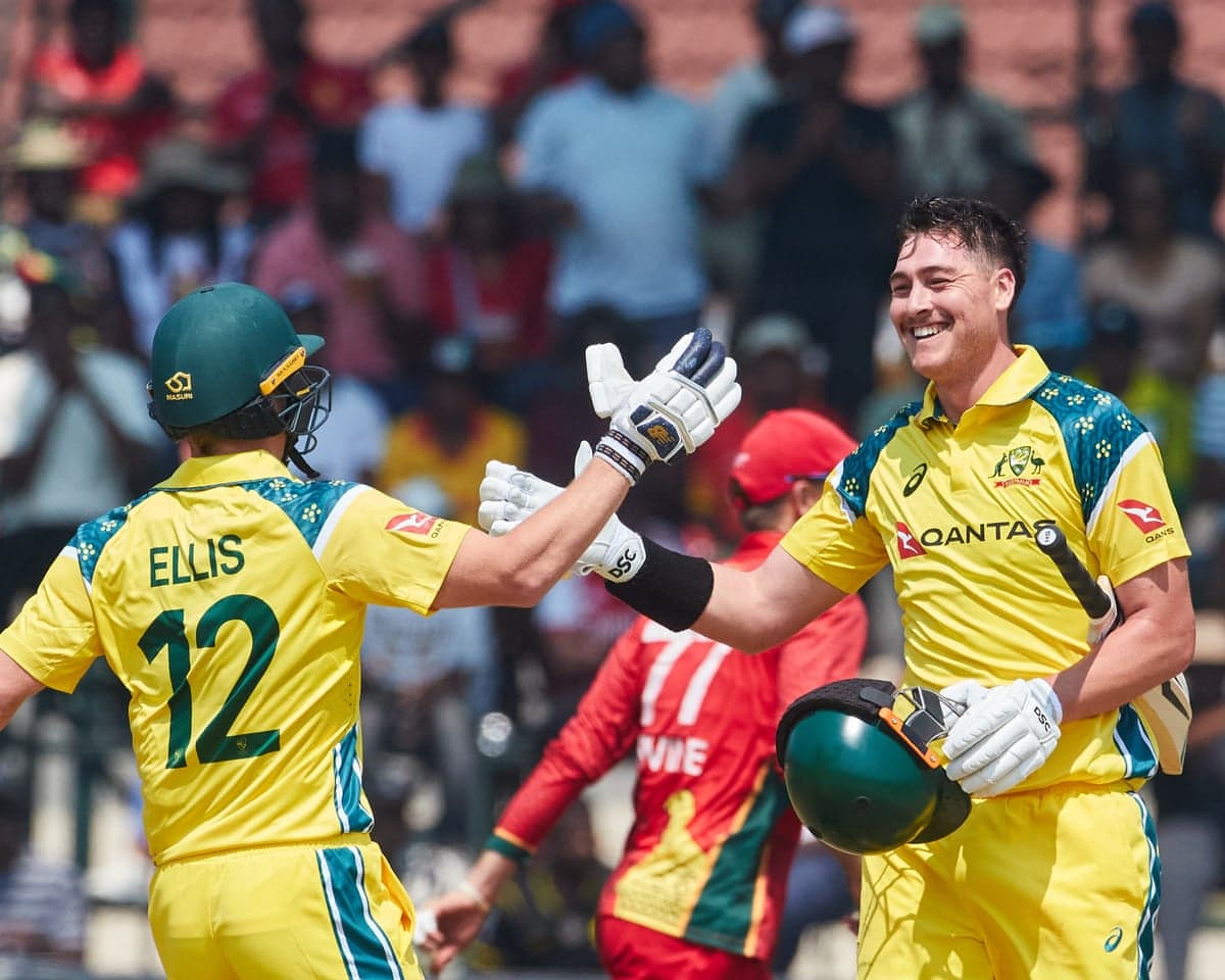 Australia's Matthew Renshaw celebrates with Nathan Ellis on reaching 100 against Zimbabwe in the first ODI in Harare.