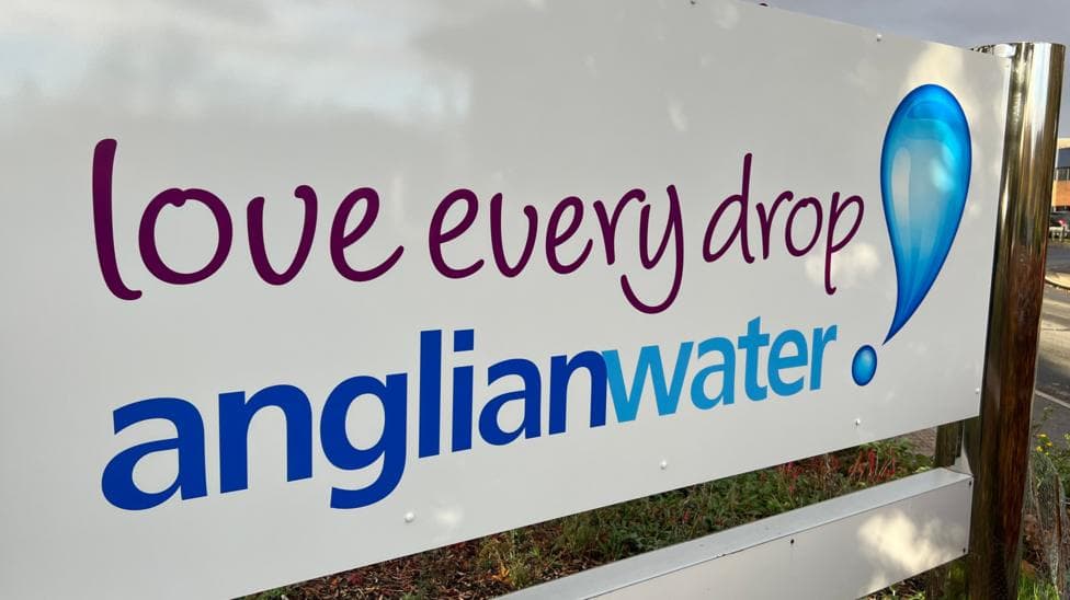 The photo shows a white sign which reads in blue text 'Love every drop. Anglian Water'