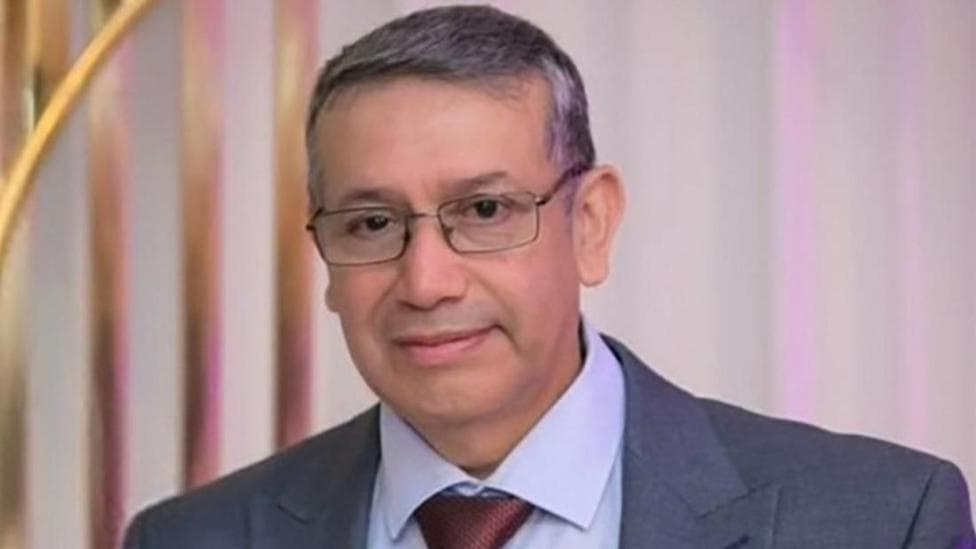 Jorge Ortega in a suit and glasses.