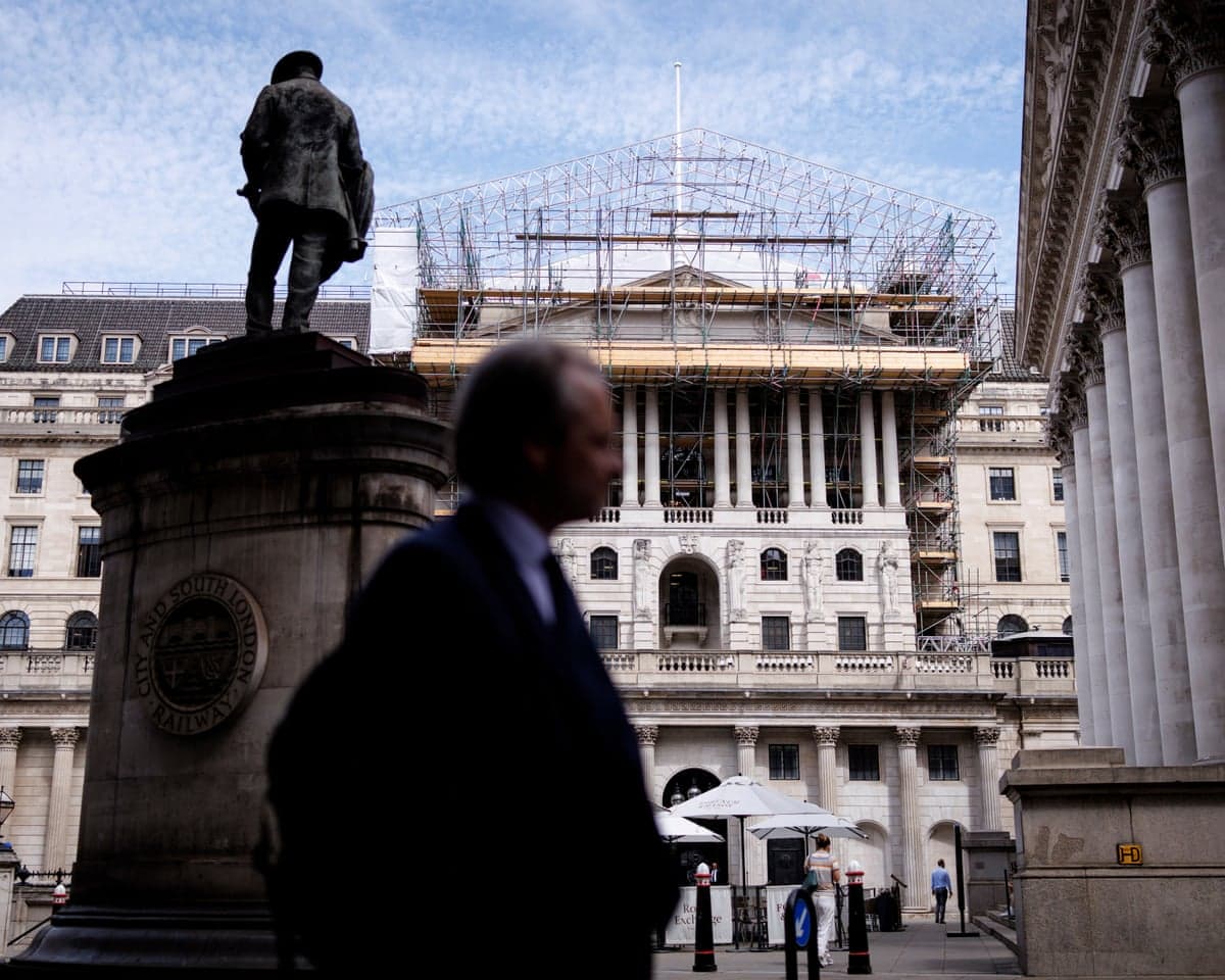 People pass the Bank of England