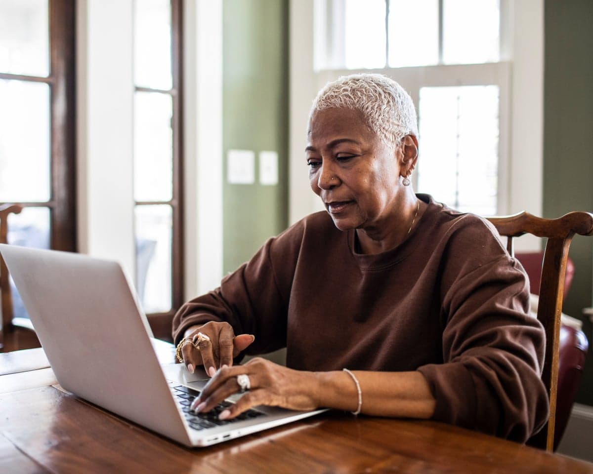 Senior woman using laptop at home