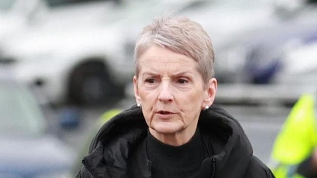 Lady Eleanor Donaldson arriving at Newry Crown Court. She has short grey hair, wearing a black coat.