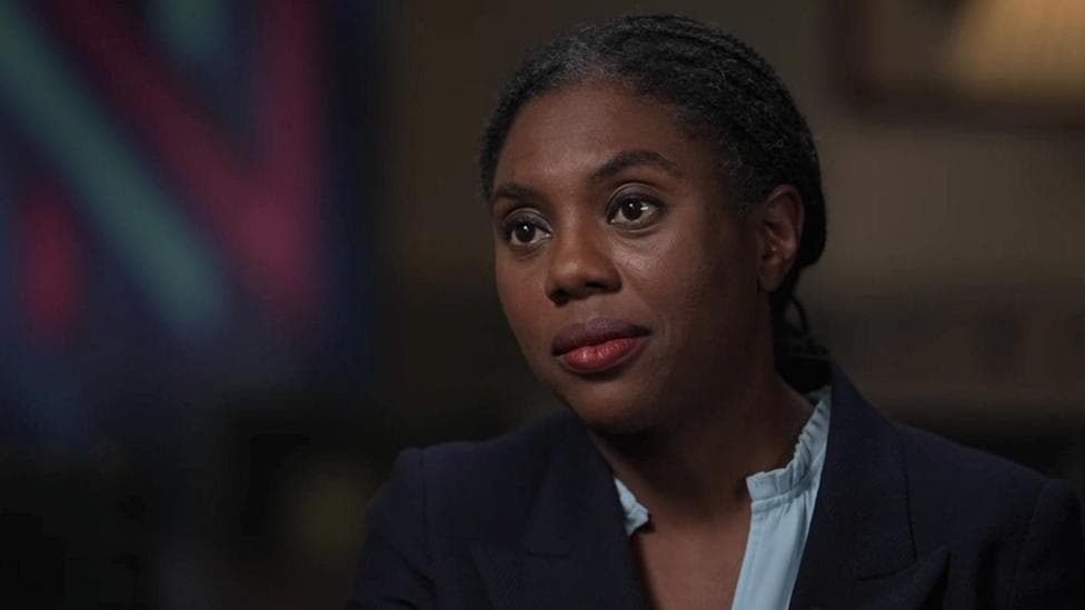 Conservative Party leader Kemi Badenoch has a serious expression as she is interviewed in front of a Newsnight logo.