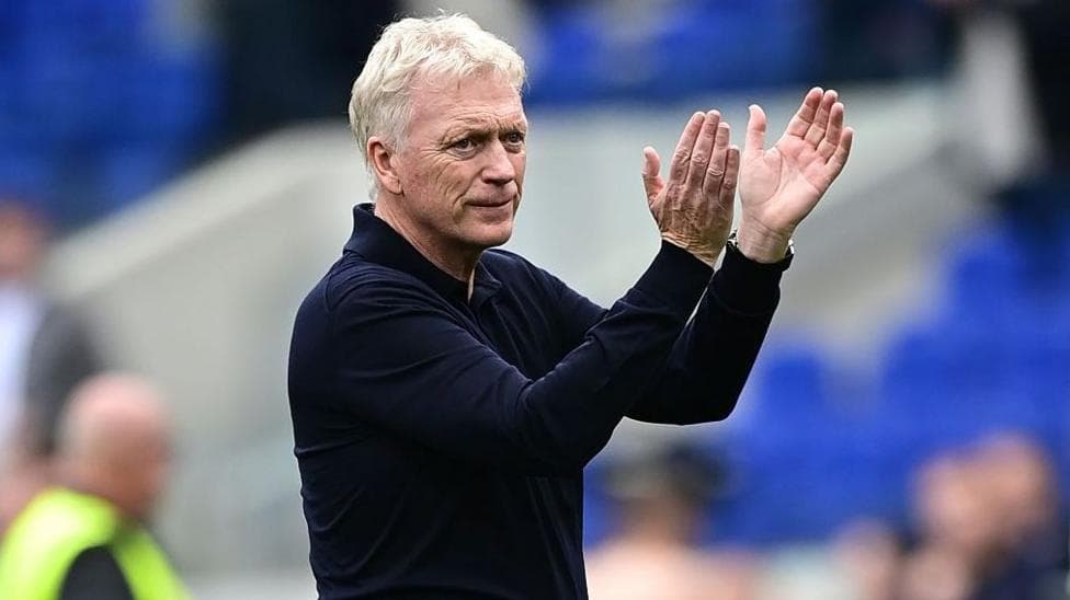 David Moyes, in a long-sleeved dark shirt, stands and applauds