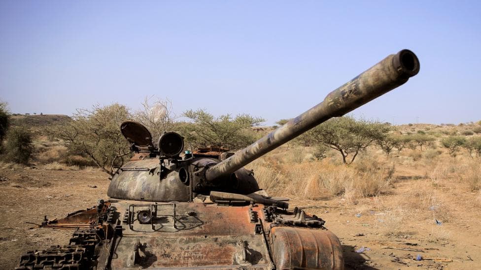A destroyed tank in a field