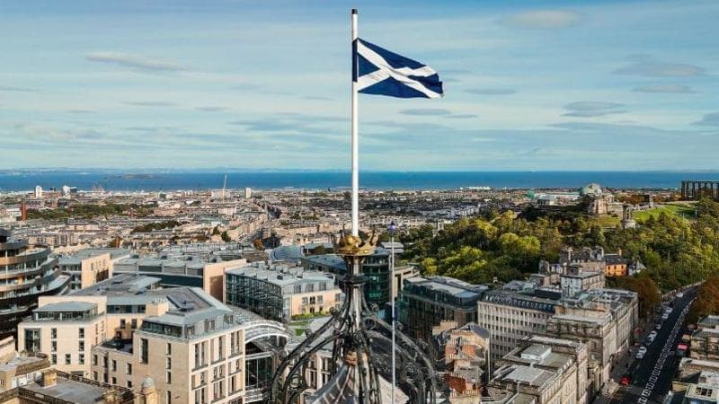 A Saltire flag flying over the Edinburgh skyline