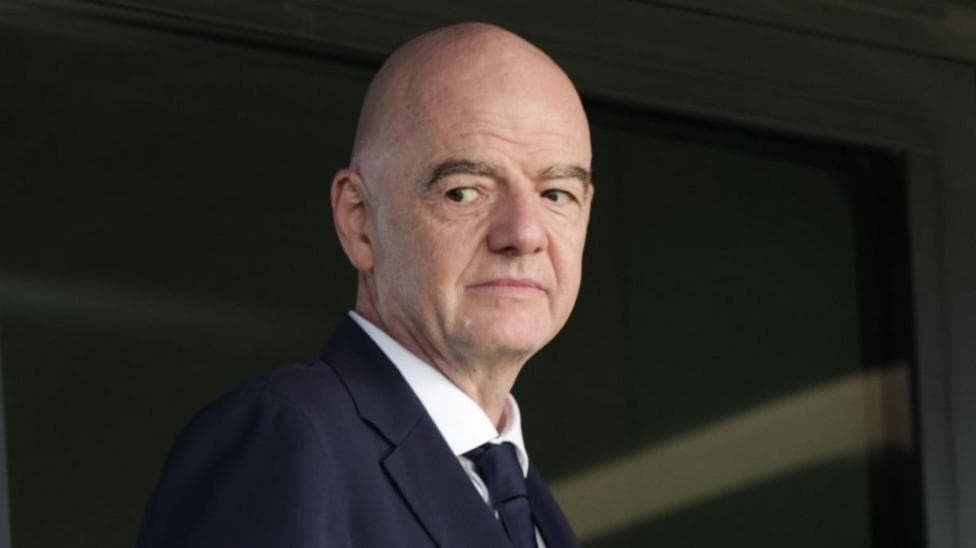 Head and shoulder view of Gianni Infantino looking to his right, as he wears dart jacket and tie and a white shirt