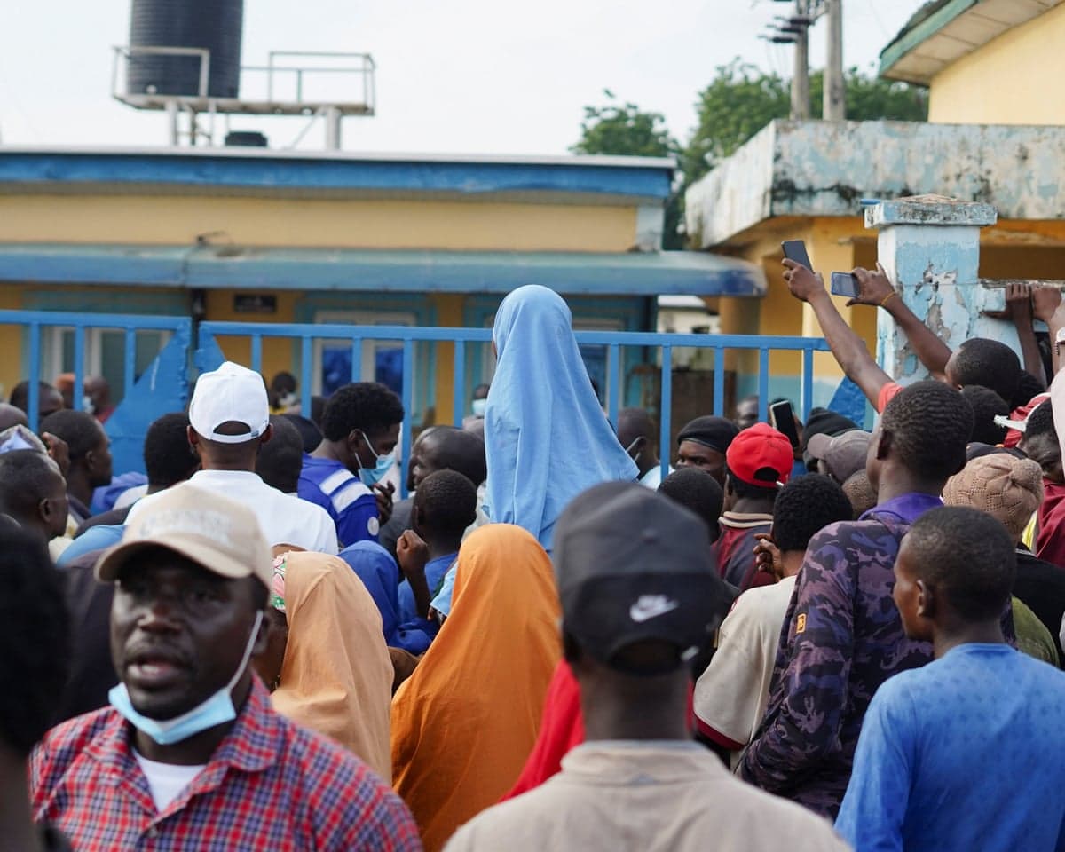 People gather outside the hospital gate
