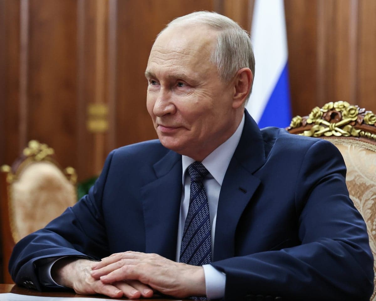 Vladimir Putin sits with his hands crossed in Moscow.