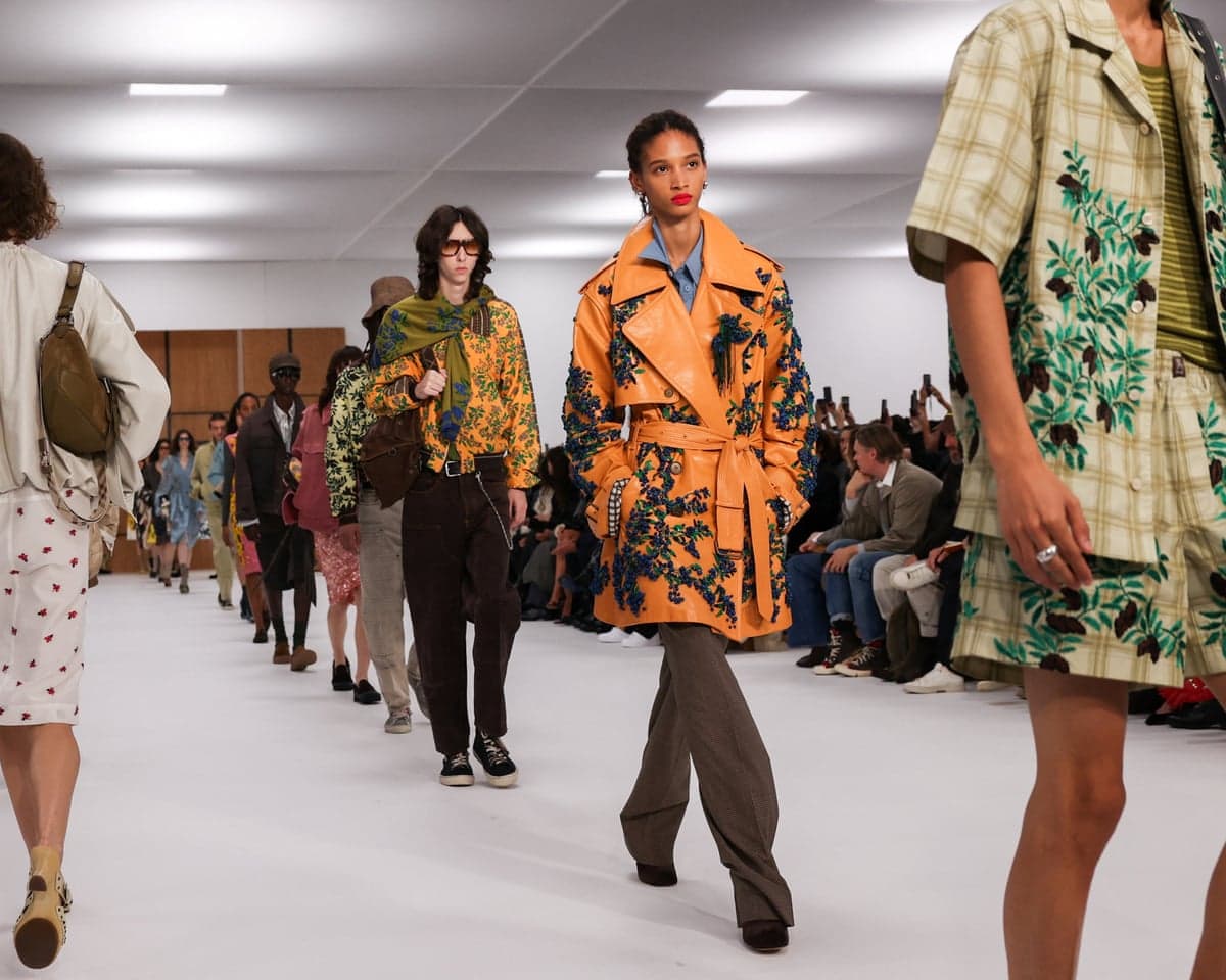 Models wearing shirts, jackets and trench coats featuring leaf-and-branch designs including one over a Burberry check