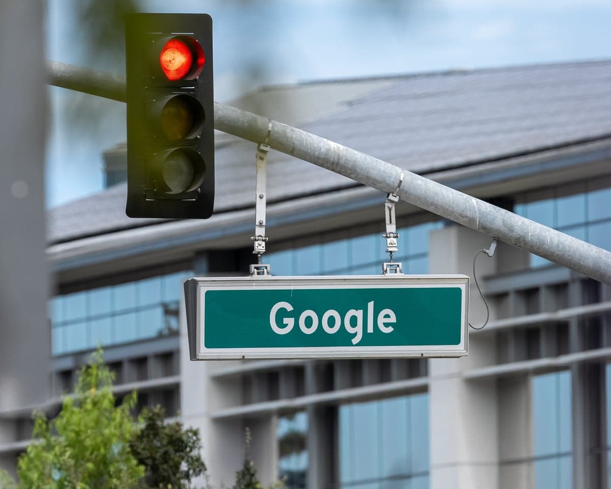 A street sign saying Google, next to a traffic light showing red, near the headquarters in Mountain View, California