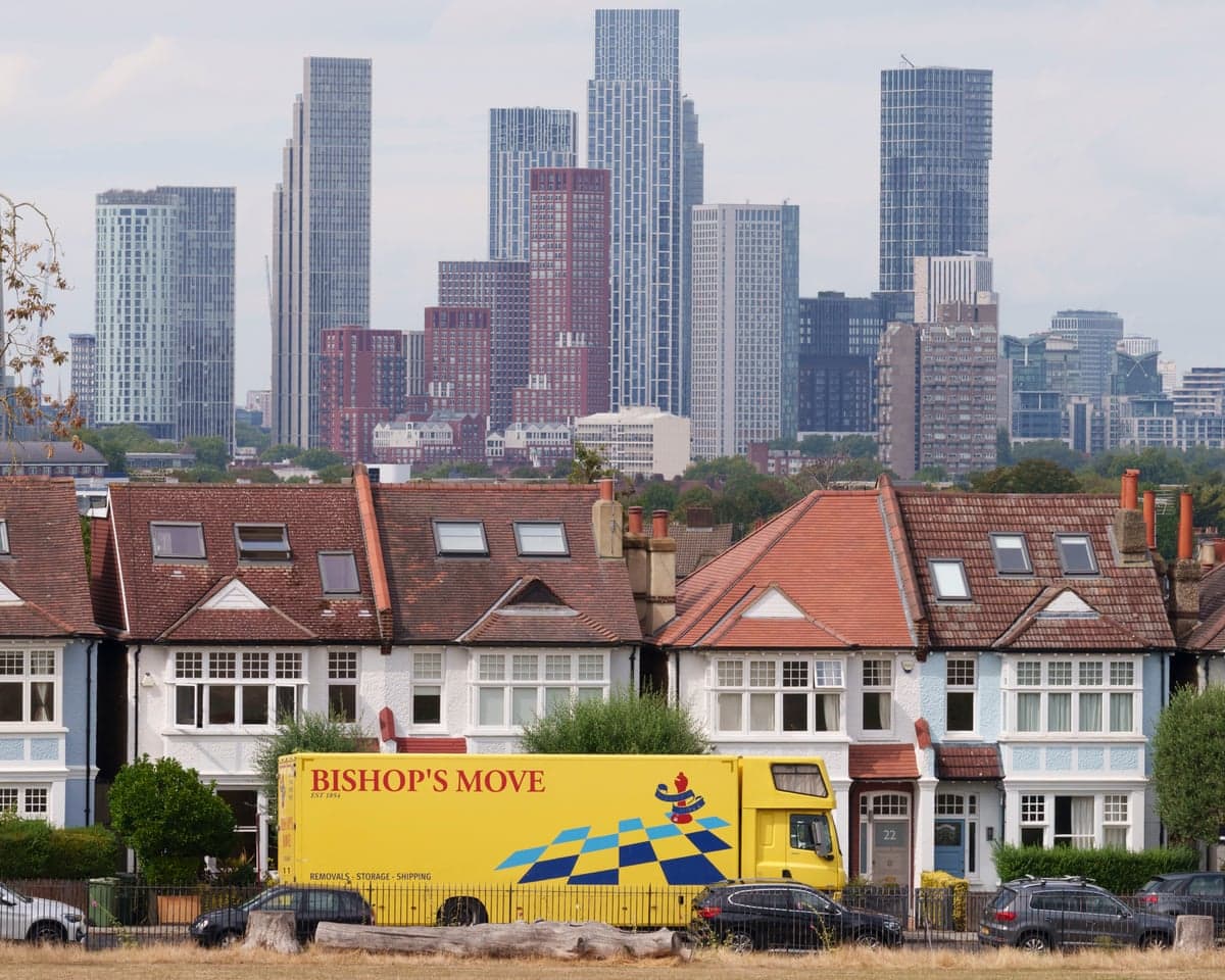 A removals lorry in front of a row of houses