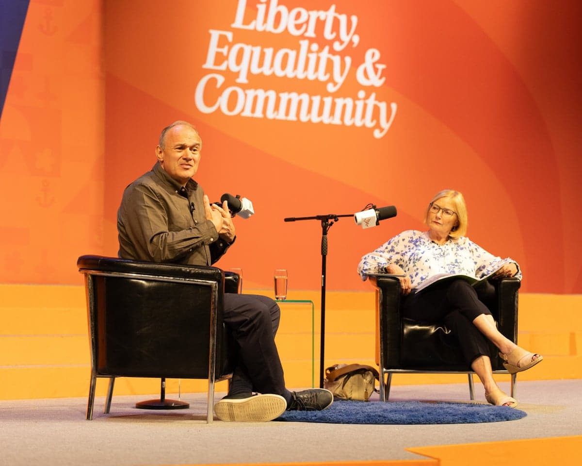 Ed Davey seated opposite Carolyn Quinn for a stage Q&A under the word 'Liberty, Equality and Fraternity' at the Lib Dem conference