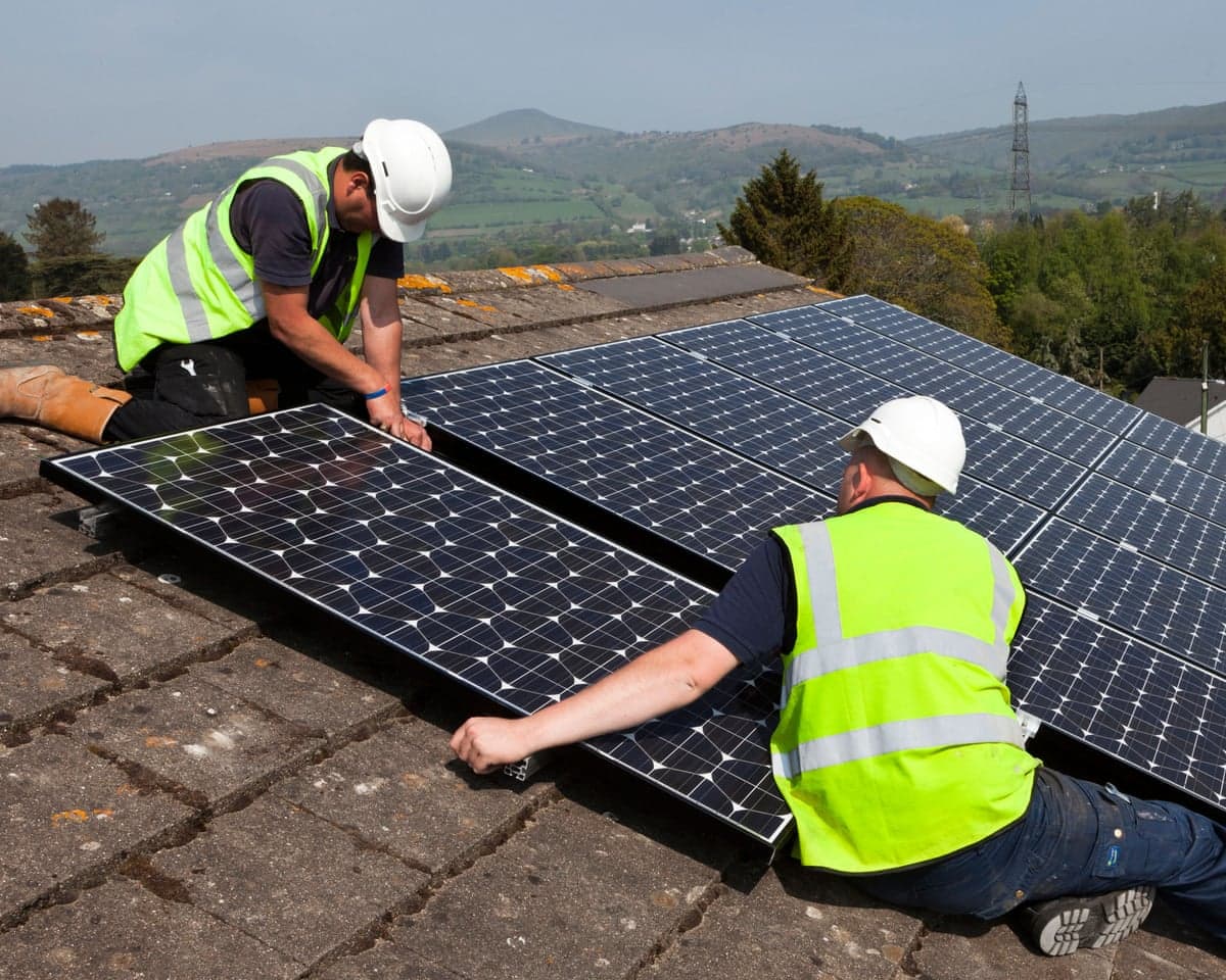 Solar panels being fitted on a roof in Wales.