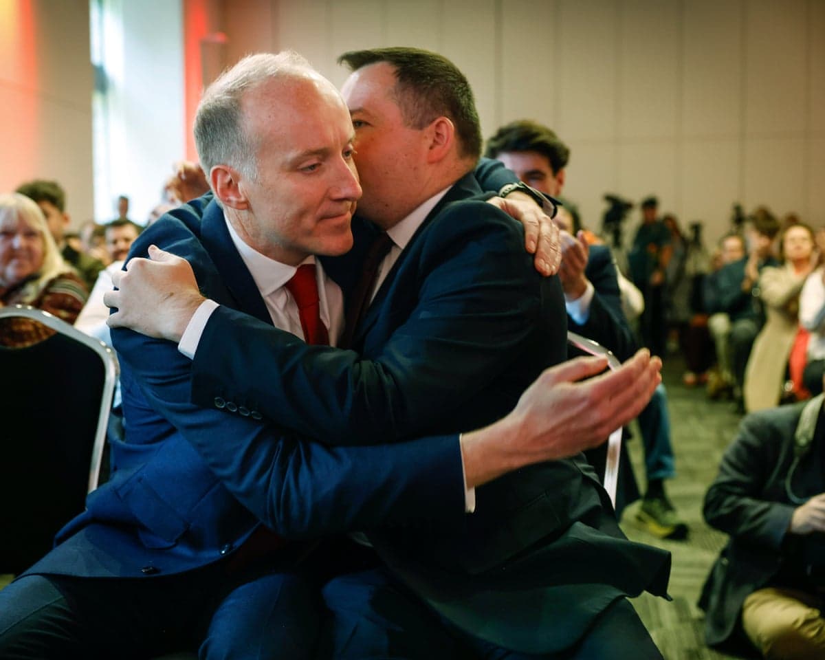 Michael Marra (left) hugs his main rival, Joe Fagan (right).