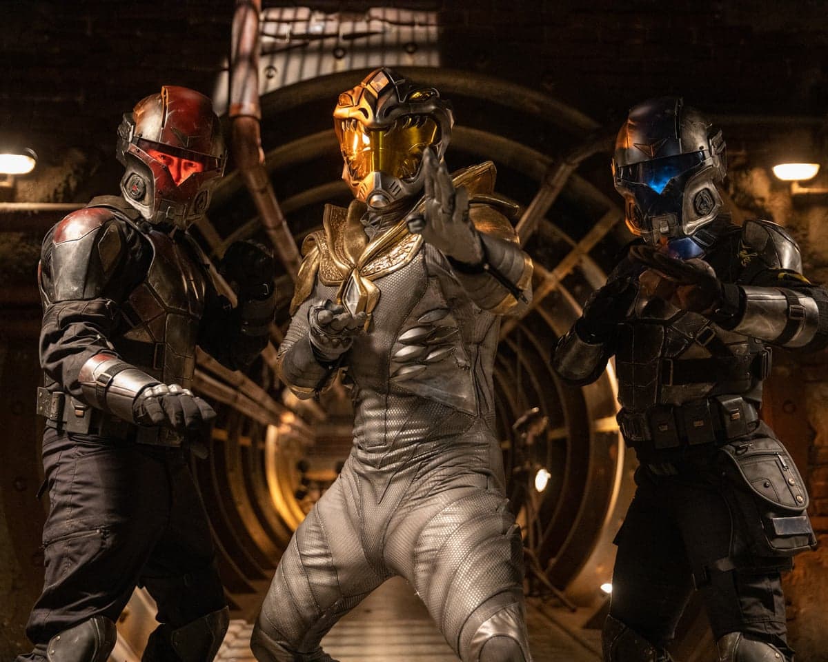 Three armored, helmeted warriors stand ready to fight in a dim tunnel, from Legend of the White Dragon