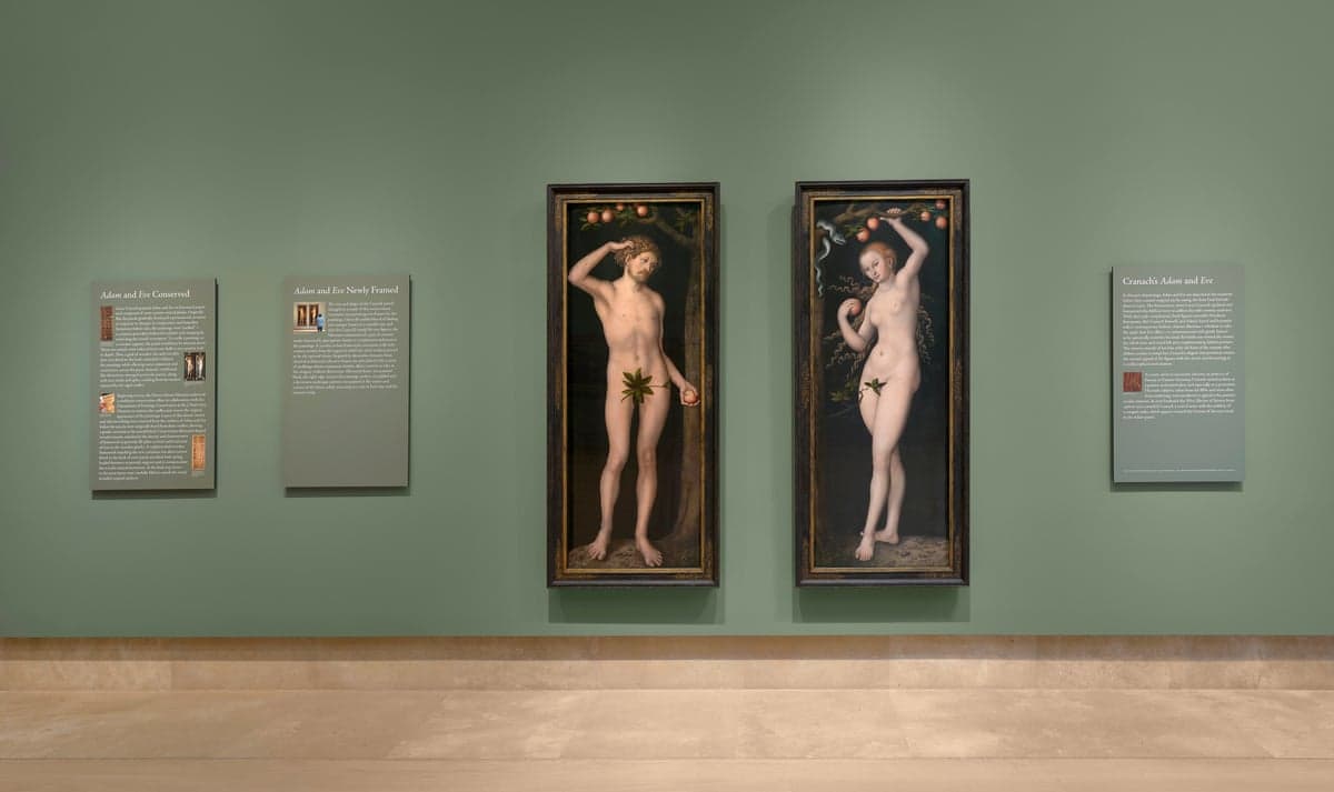 A diptych of Adam and Eve hangs on a museum wall