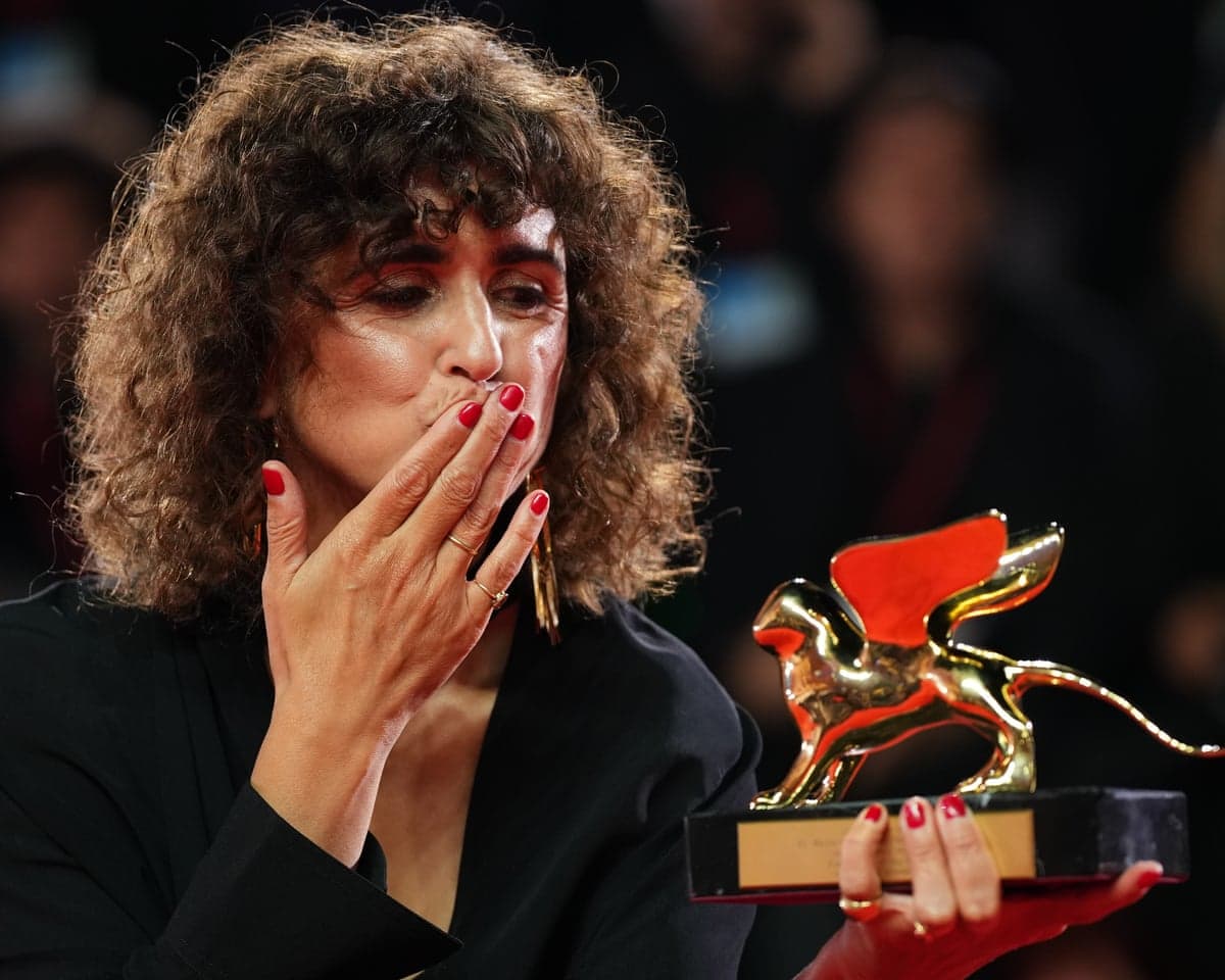 May el-Toukhy blows a kiss to her Golden Lion award on the Venice film festival red carpet