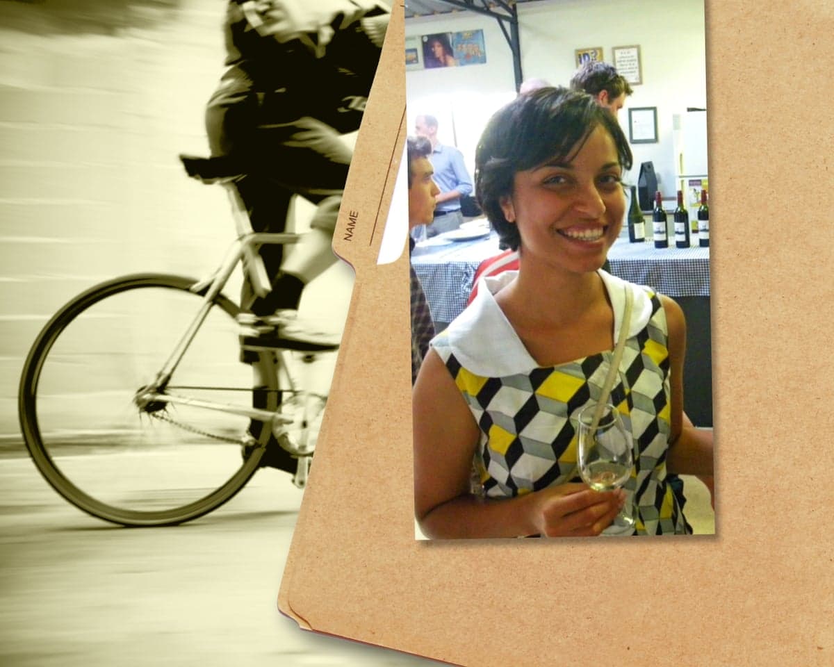 Composite image of a photograph of a smiling woman holding a wine glass, pinned to cardboard, beside a blurred image of a cyclist
