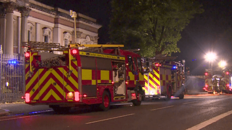 Red and tellow fire appliances outside the former courthouse on Crumlin Road in north Belfast