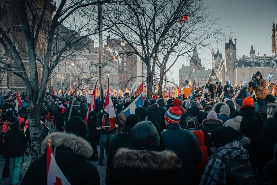 Crowd gathered in Ottawa, Canada for a street protest on a cold winter day.