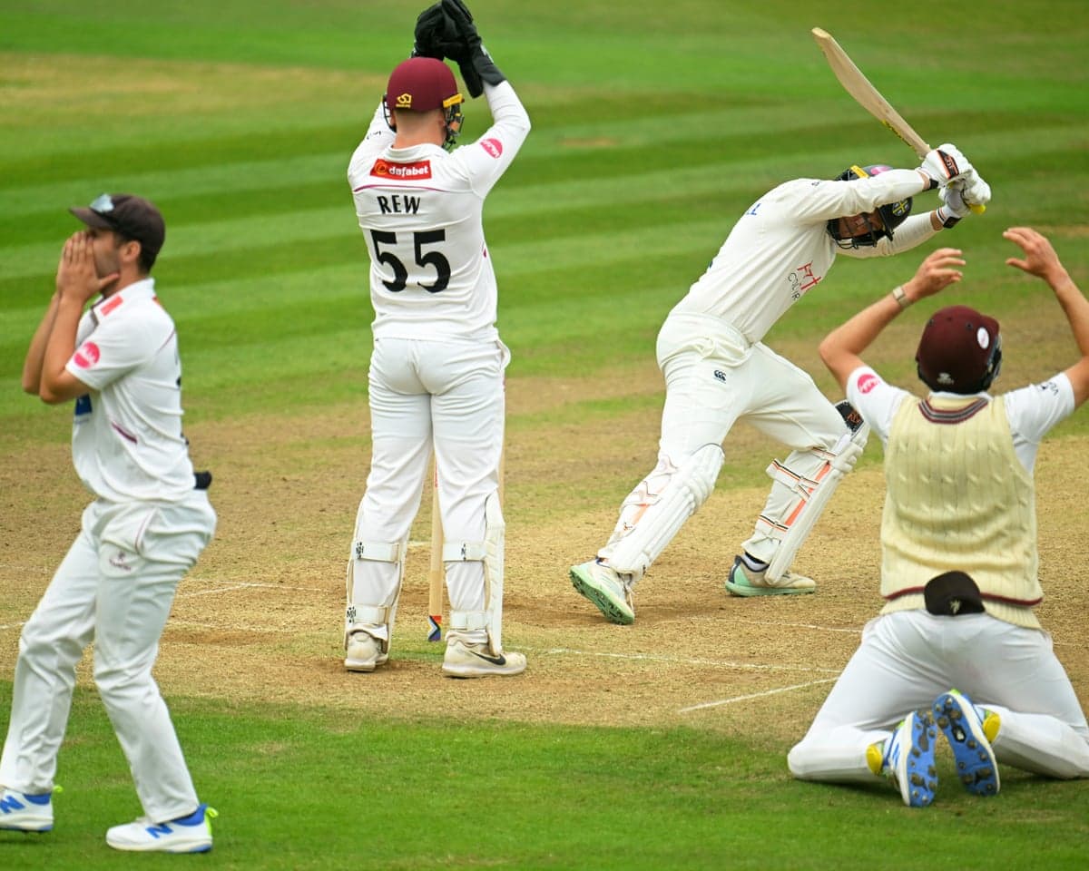 Lewis Gregory, James Rew and Craig Overton of Somerset react as the batter George Drissell of Durham looks on