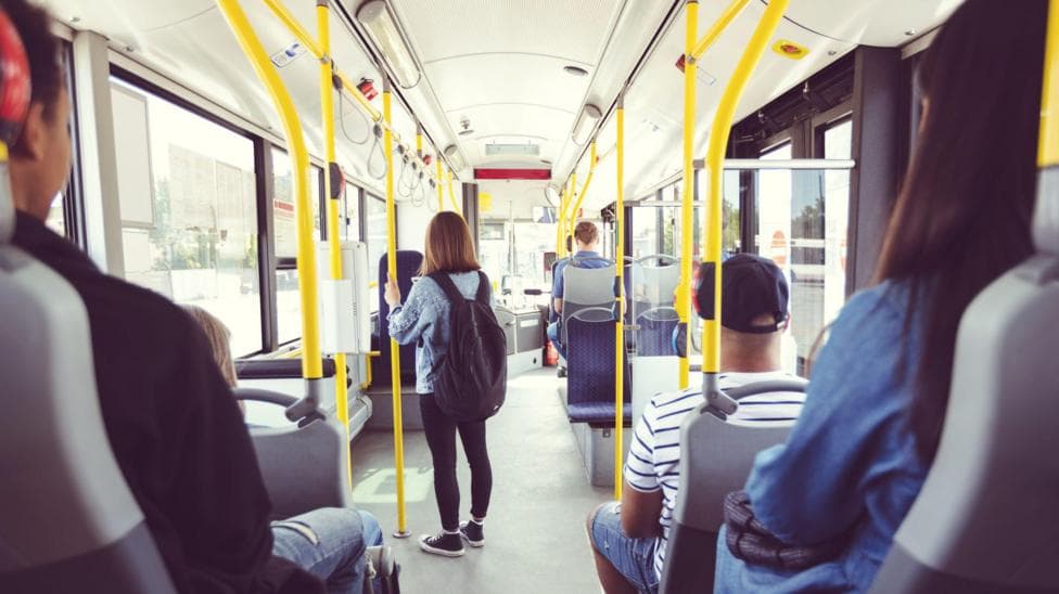 Males and females commuting by public transport - stock photo
Men and women traveling in public transport. Teenage girl is standing at aisle while commuting by bus. They are in vehicle.