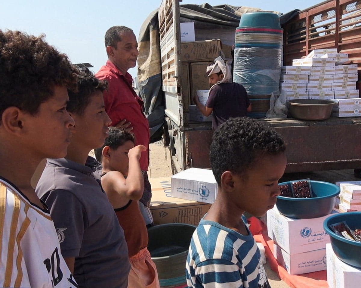 Children displaced by war wait to collect food aid at a camp for internally displaced people near Aden, Yemen, on 23 September 2026.