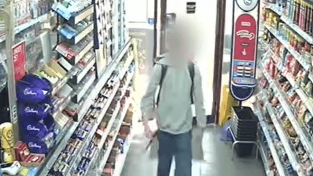 CCTV of boy carrying knife in shop. HIs face is blurred.