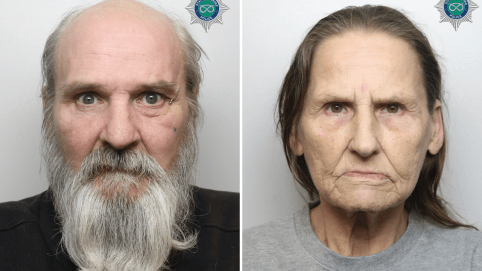 A composite image comprised of two police mugshots. On the left is a man with a long grey beard, and on the right a woman with shoulder length brown hair