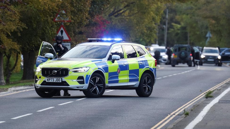 A police car is pictured on a road