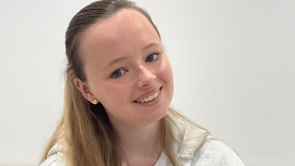 A photo of University of Gloucestershire student Ofelia Bines. She has long light-brown hair and is wearing a white top