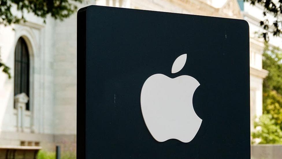 Apple logo illuminated on a black sign outside an Apple Store in Washington DC