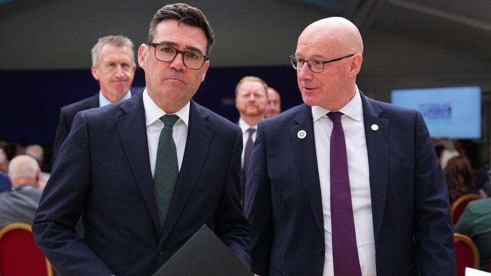 Two men in business suits walk side by side