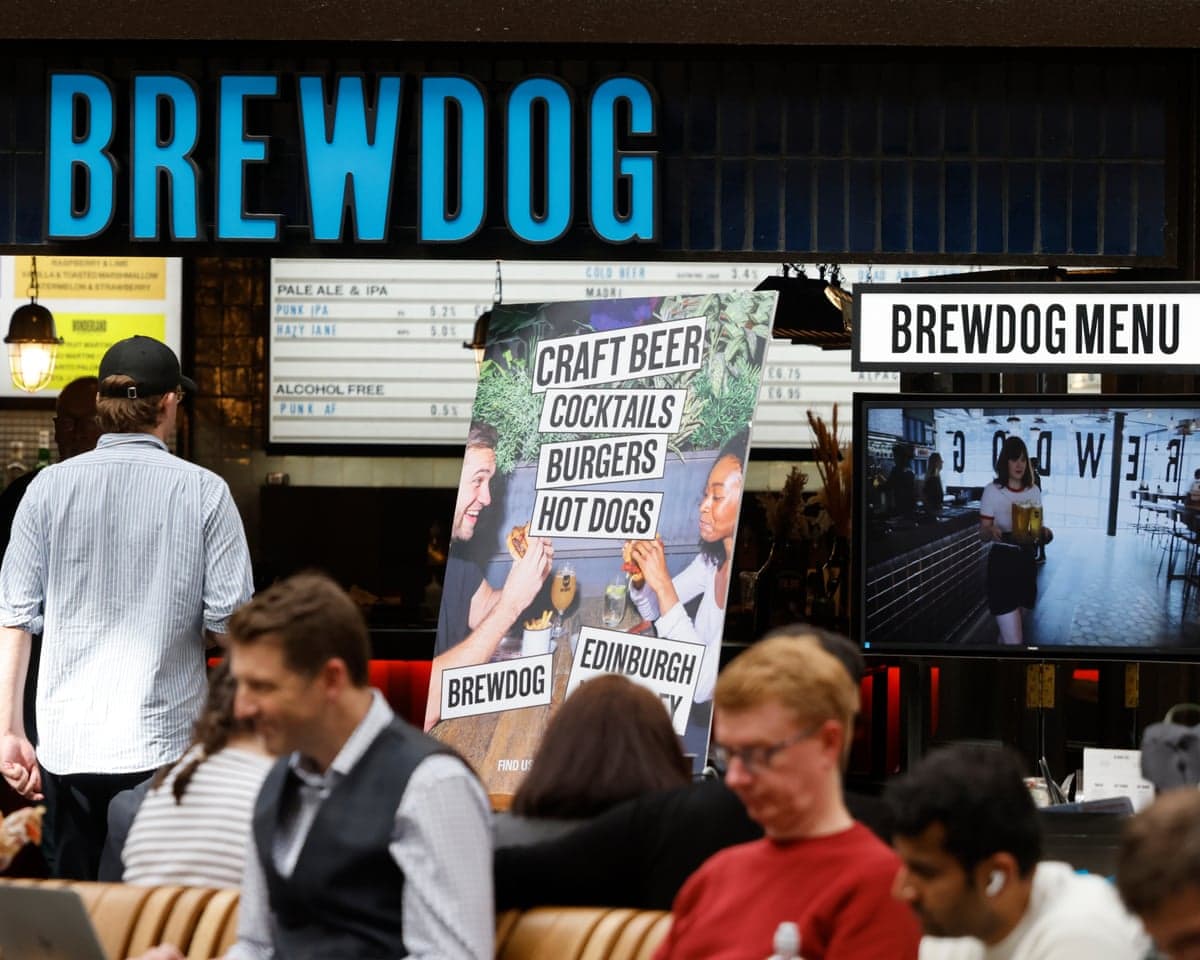 The BrewDog bar at Waverley railway station in Edinburgh with people sitting in the foreground