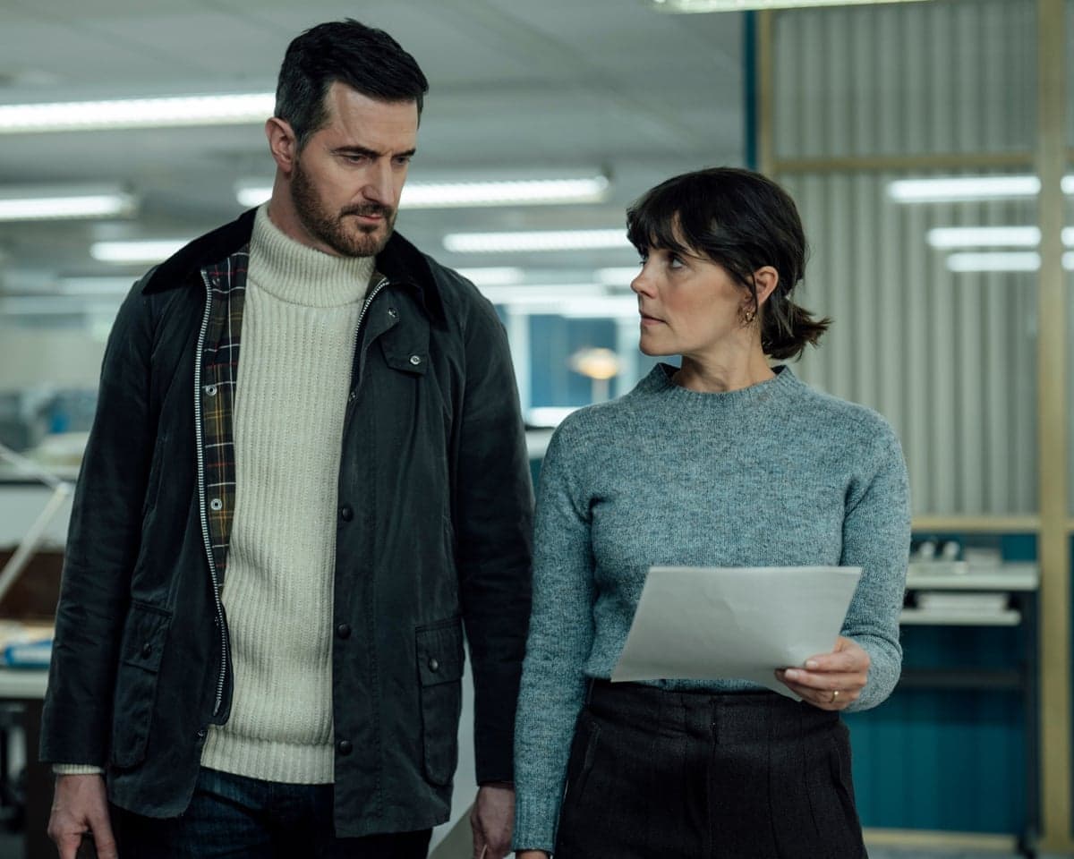 Ethan Winter and Lauren Bell stand in an office in ITV drama Winter.
