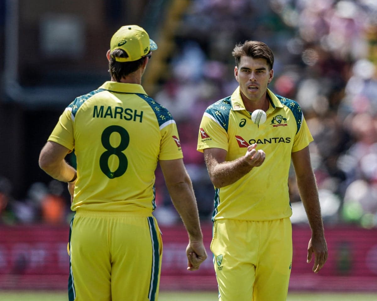 Xavier Bartlett speaks with teammate Mitchell Marsh as he prepares to bowl