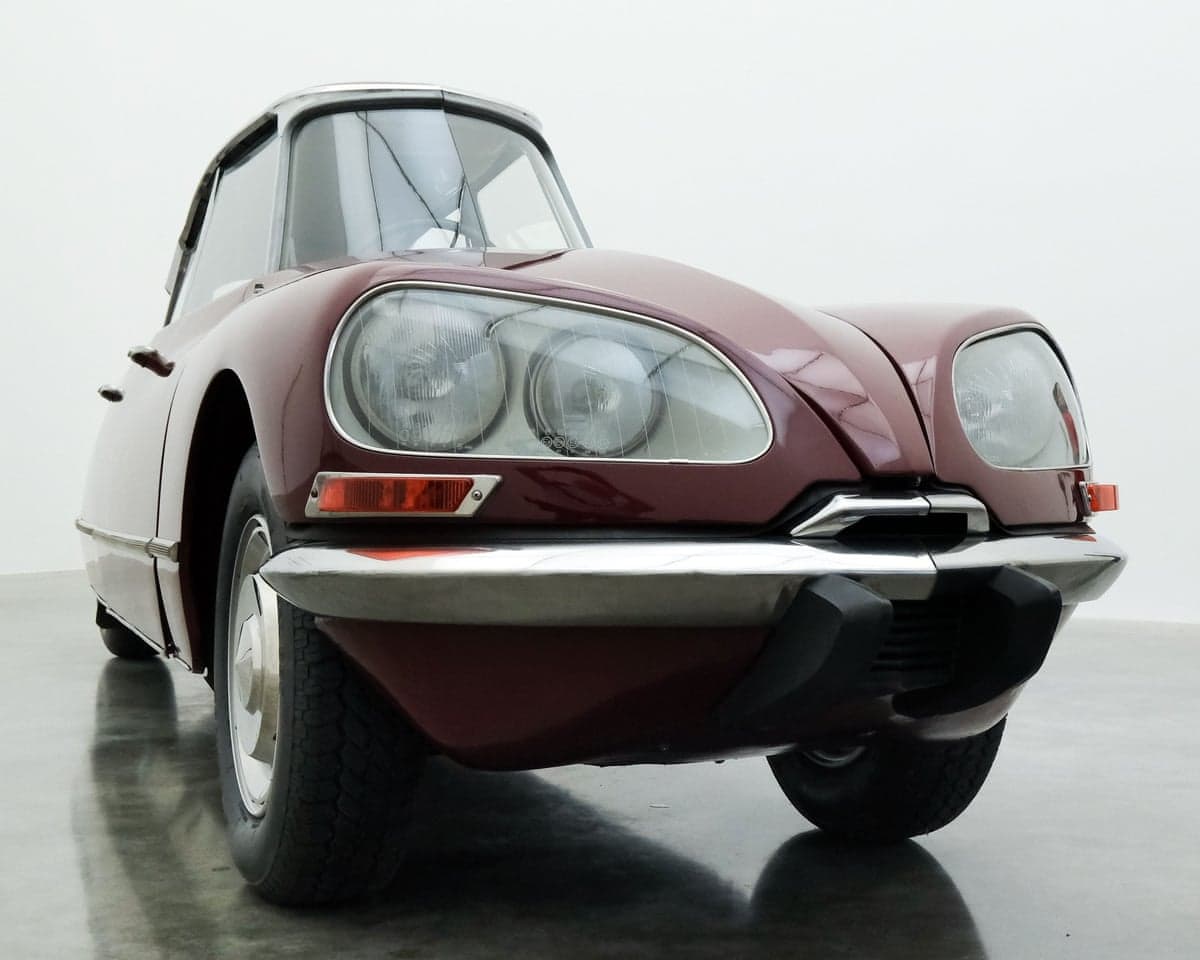 Gabriel Orozco's modified maroon Citroën DS sculpture is displayed in a gallery
