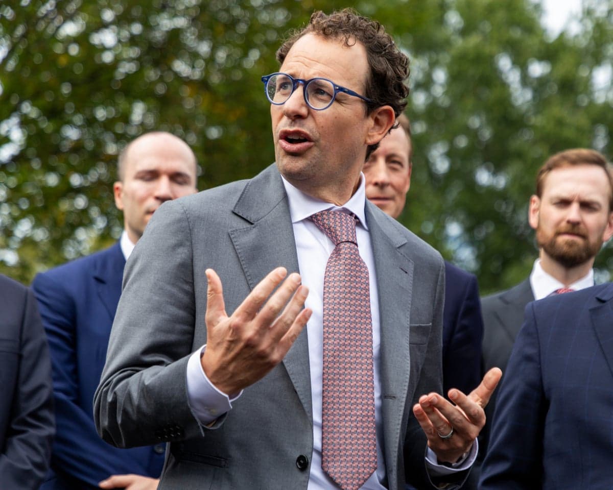 a man speaks in front of other men