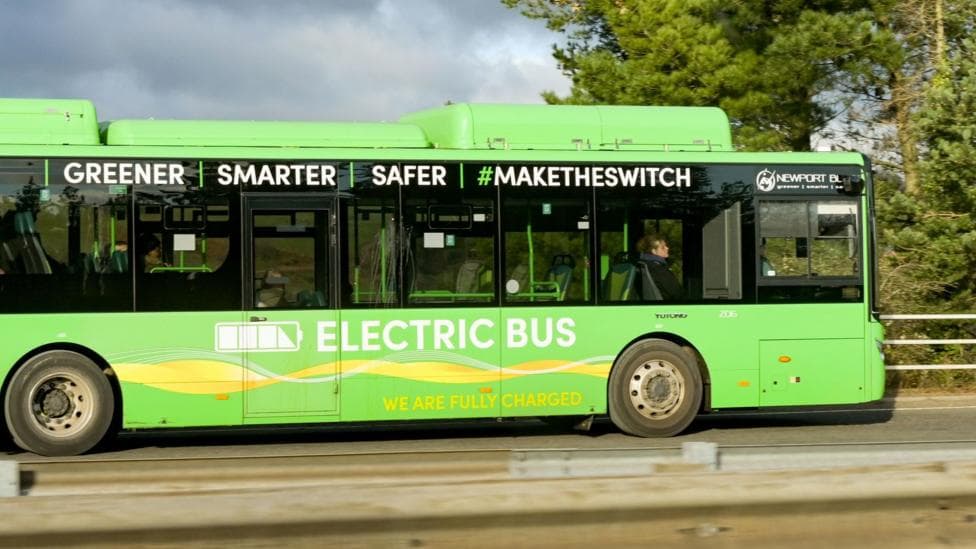 A green Newport Bus on a road in south Wales